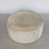 top view of the extra large cowhide round ottoman in light colored tones