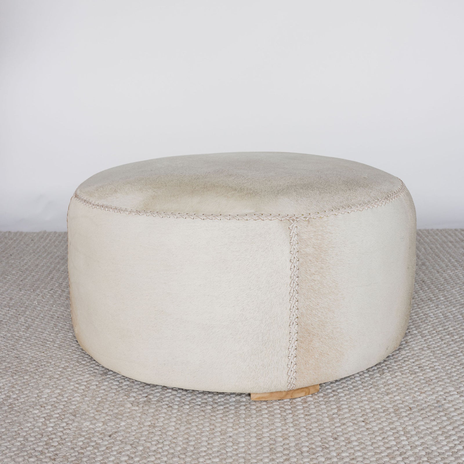 light cream and caramel colored hide ottoman coffee table by corcovado design