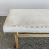 close up of one end of the narrow cowhide bench seat ottoman