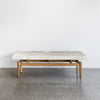 cowhide bench seat ottoman from corcovado with shades of cream and gray on the top of the hide