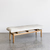 angled view of the cowhide bench seat ottoman from corcovado with shades of cream and gray on the top of the hide