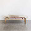 side view of the of the brown and cream cowhide bench seat by corcovado