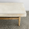 close up  of the brown and cream colored cow hide bench seat ottoman