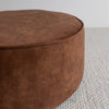 close up detail of the  low, round velvet ottoman in a cinnamon color from corcovado