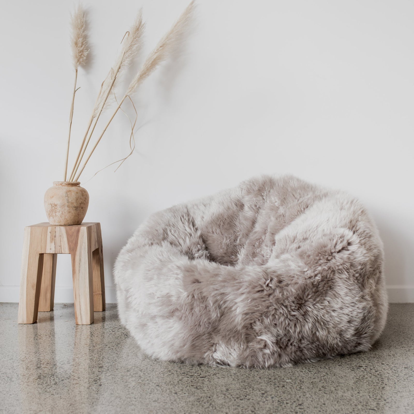 pure wool New Zealand sheepskin bean bag chair in a light gray color 